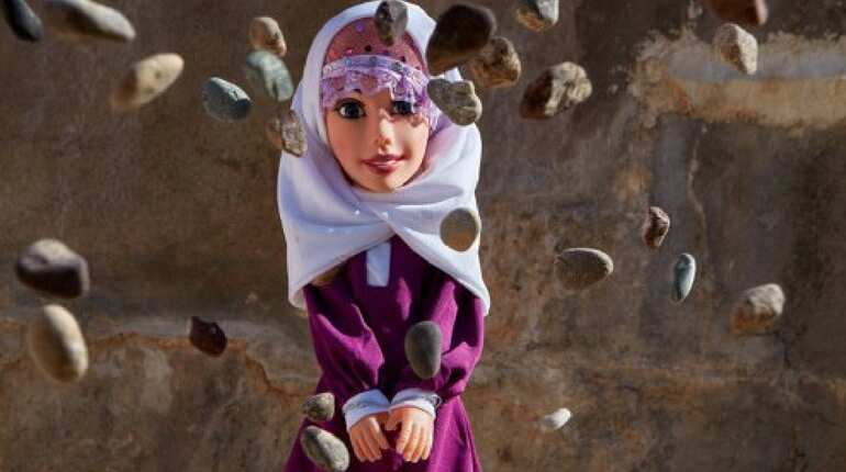 Doll being pelted with stones