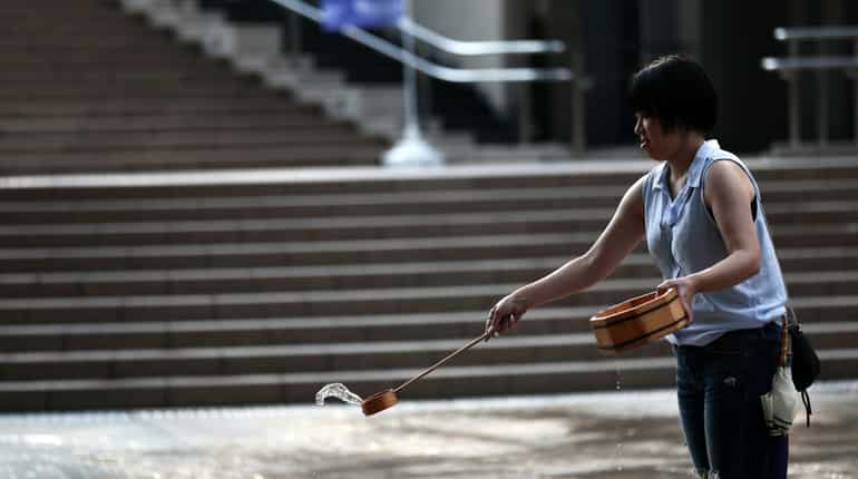 A women splashes water on the ground