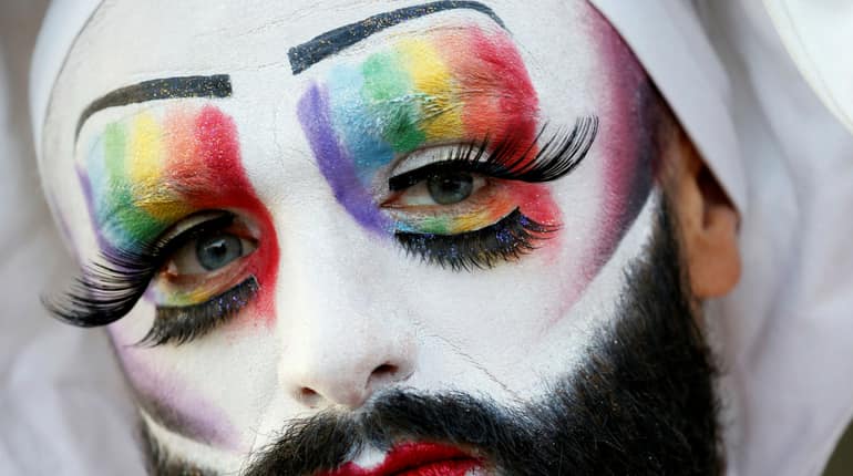 A participant poses at the Gay Games village
