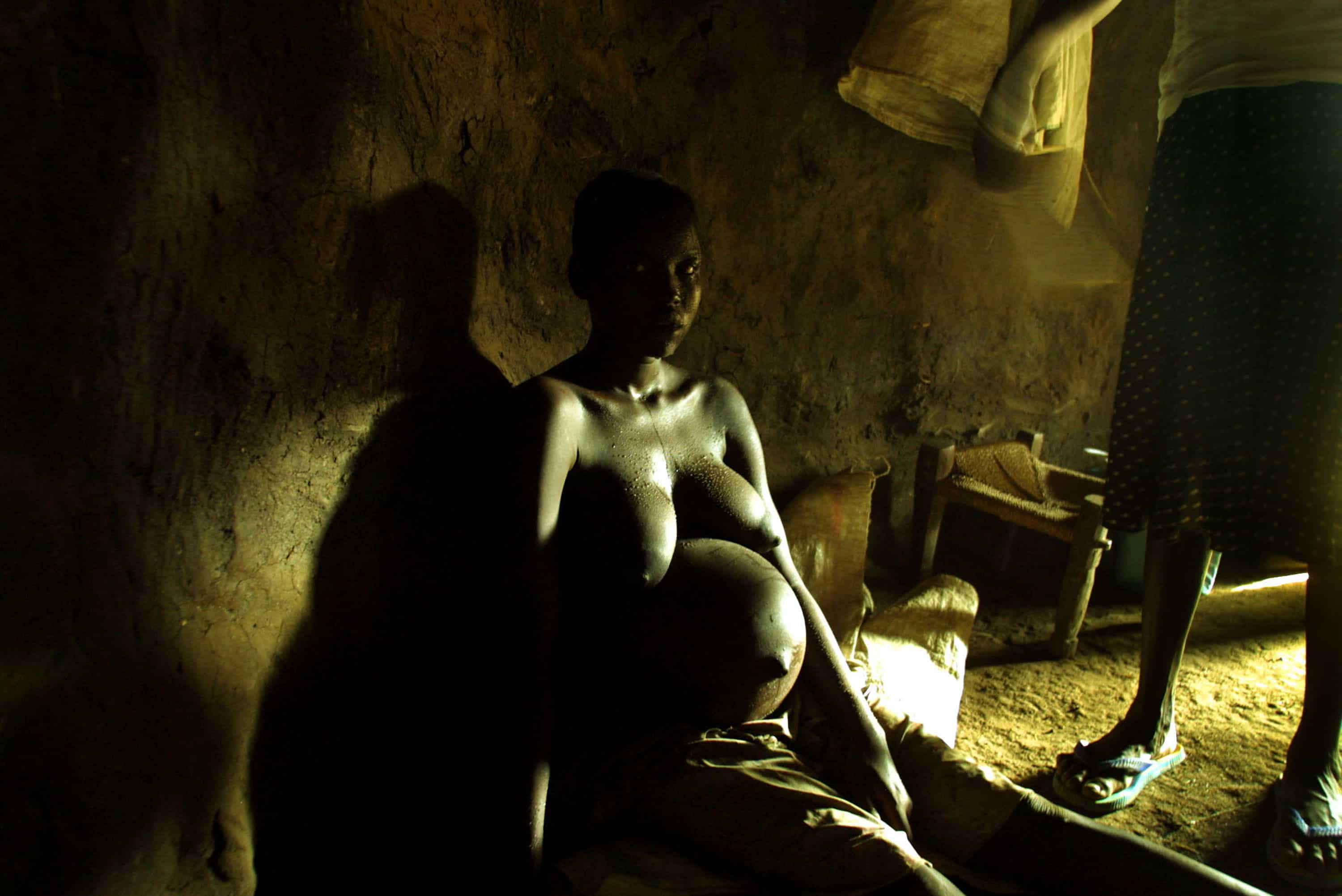 Ruth, a teen belonging to the Uduk tribe, prepares to give birth to her first child March 12, 2003 at the Bonga Refugee camp on the Sudan-Ethiopia border.
