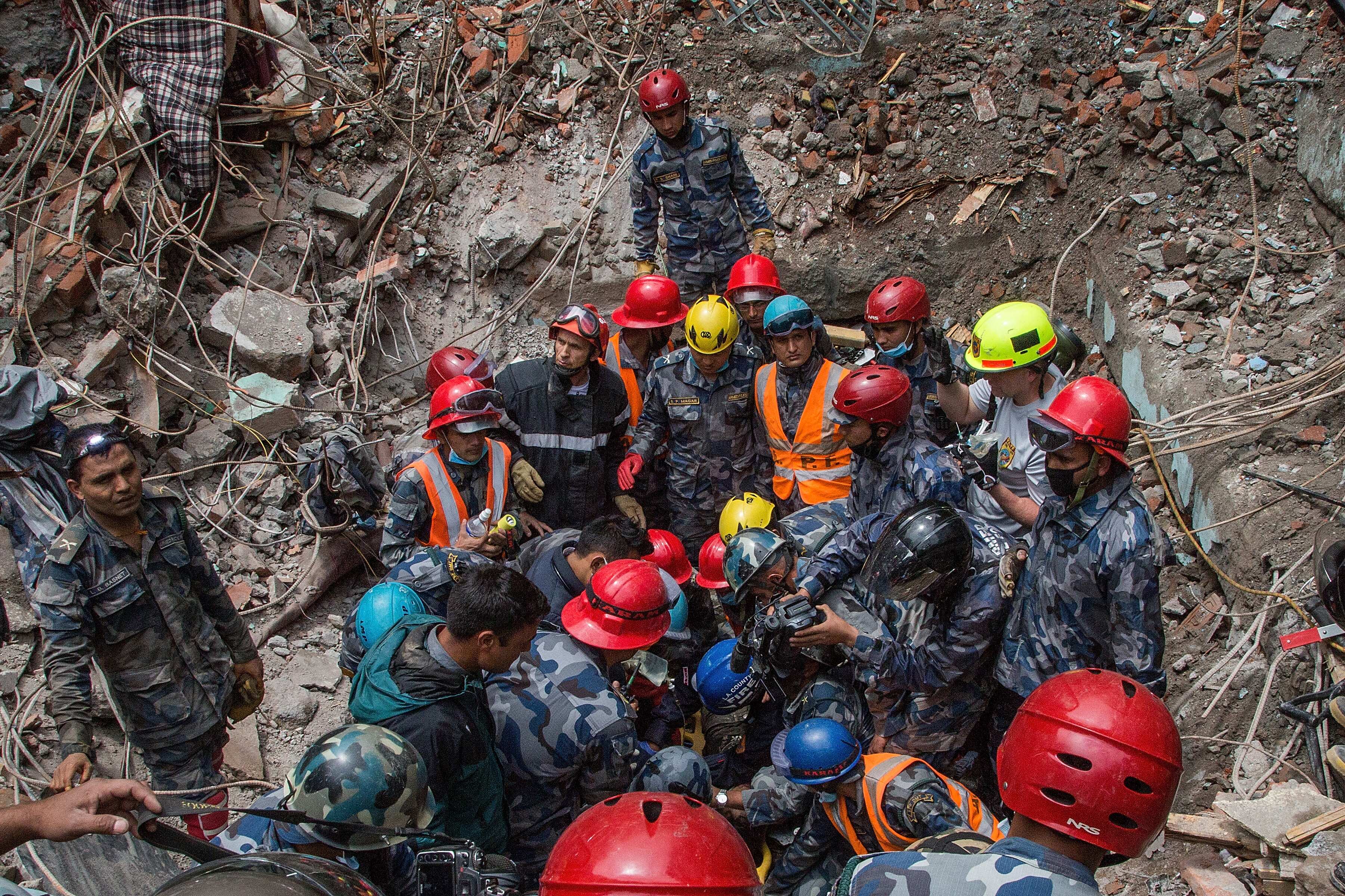 Nepal army forces, in collaboration with an American search and rescue team, save 15-year-old Pemba Lama from a collapsed hotel five days after the 2015 earthquake hit Kathmandu.