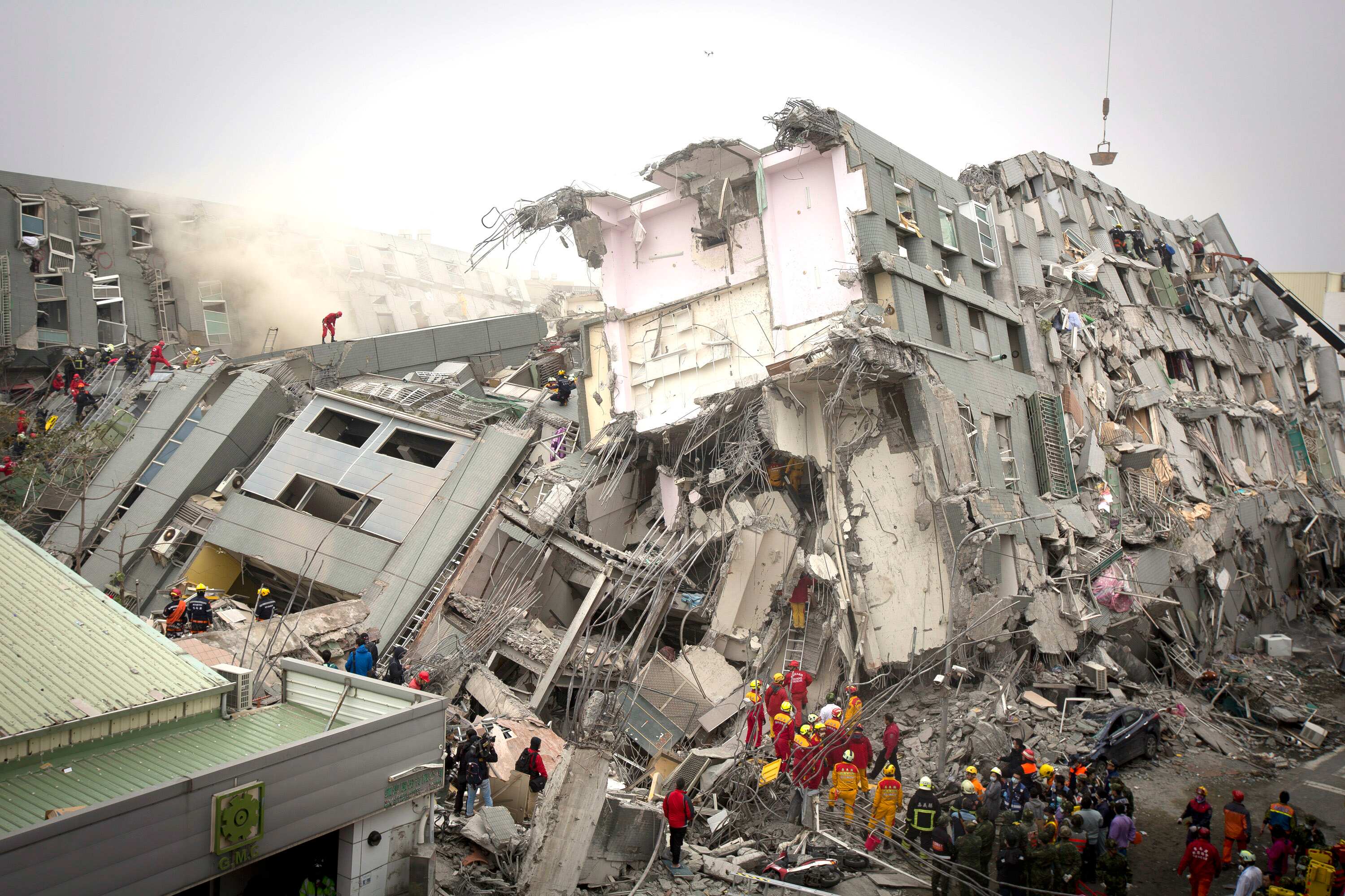 Rescue personnel search for survivors at the site of a collapsed building in Tainan, Taiwan