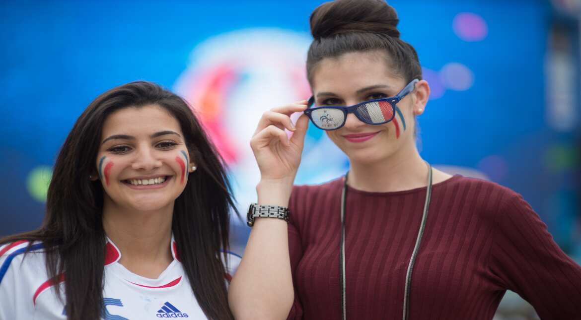 Fans pose at the UEFA EURO Fan Zone near the Eiffel Tower, June 10, 2016 in Paris, France. The UEFA EURO 2016 kicks off on June 10 with the first match between Romania and France. (Photo by Thierry O