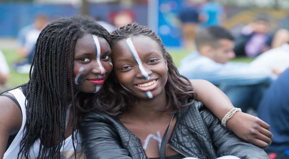 French fans pose at the UEFA EURO Fan Zone near the Eiffel Tower, June 10, 2016 in Paris, France. The UEFA EURO 2016 kicks off on June 10 with the first match between Romania and France. (Photo by Thi