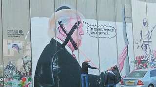 Watch: Now, Palestinians bring down Trump's mural in Bethlehem