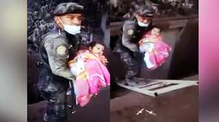 Watch: As volcano rages, Guatemala Police rescue baby girl