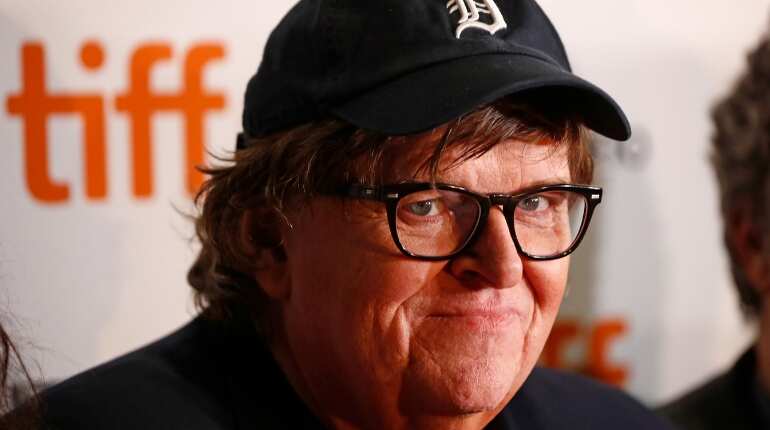 Michael Moore calls Trump a 'virus' as he discusses liberating Michigan with host Stephen Colbert