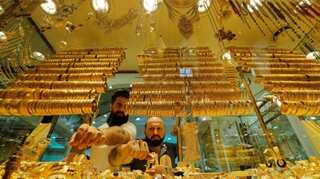Gold holds near six-week lows after upbeat US data