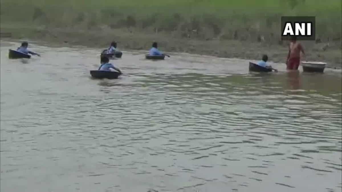 Watch: Students in Assam cross river using aluminium pots to reach school Watch: Students in Assam cross river using aluminium pots to reach school