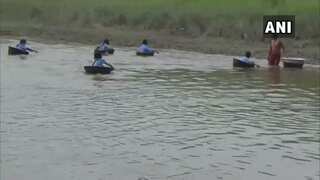 Watch: Students in Assam cross river using aluminium pots to reach school