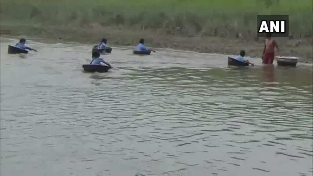 Watch: Students in Assam cross river using aluminium pots to reach school