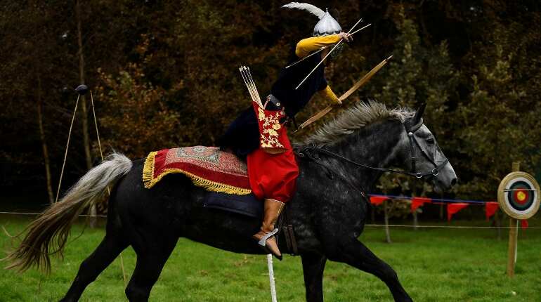 Gokmen Altinkulp dressed as an Ottoman warrior rides horse Bento to demonstrate horseback archery skills