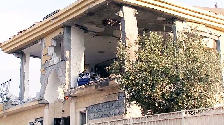 Residents clear rubble after rocket lands in Beersheba
