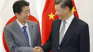 Japan, China strike deals during Abe visit as ties improve