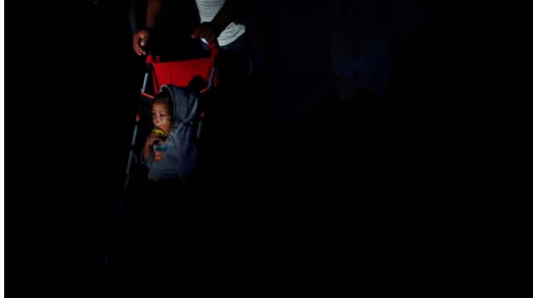 Group of men, women and children on strollers