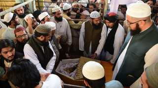 Pakistan buries 'Father of Taliban' as PM Imran Khan orders probe of killing