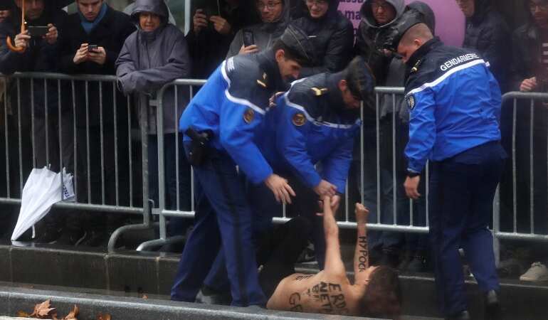 Topless protesters interrupt Trump's motorcade