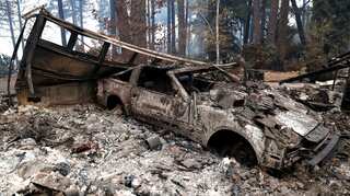 Rains douse California wildfire but raise flash flood risks