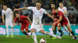 Milik's twice-taken penalty gives relegated Poland draw in Portugal