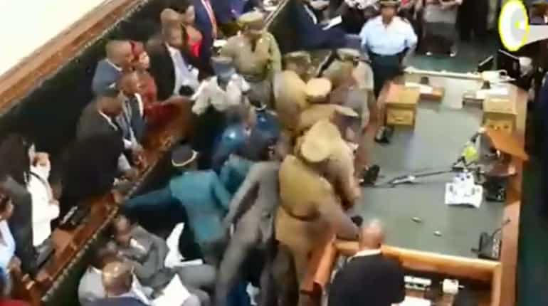 Zimbabwe opposition MPs removed from parliament after refusing to stand when president entered