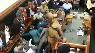 Zimbabwe opposition MPs removed from parliament after refusing to stand when president entered