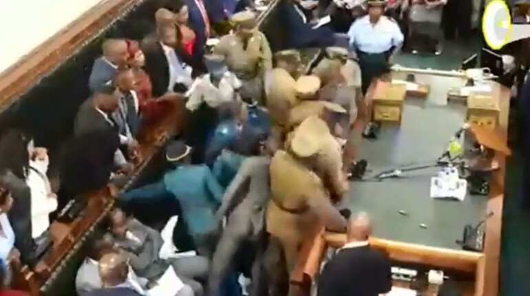 Zimbabwe opposition MPs removed from parliament after refusing to stand when president entered