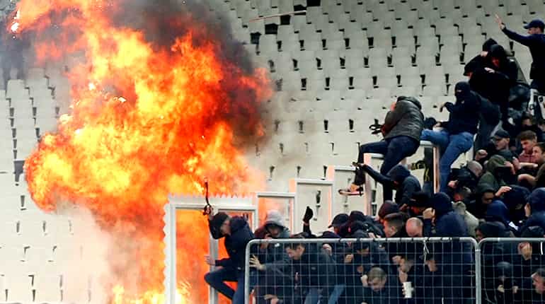 Riot police clash with Ajax fans at Champions League match