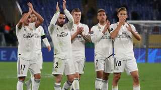 Real Madrid seal top spot with 2-0 win at Roma