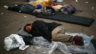 Caravan migrants in Mexico fill new border shelter after rains force exodus