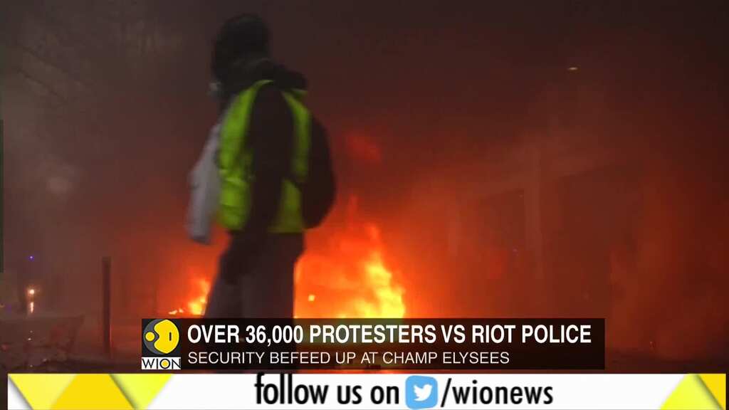 Cars burn at "yellow vest" protest in Paris