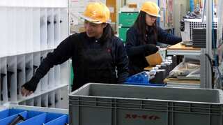 Japan enacts law to accept foreign workers despite protests