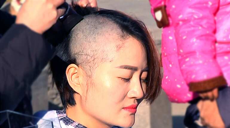 Chinese activists shave heads to protest 'persecution' of their husbands