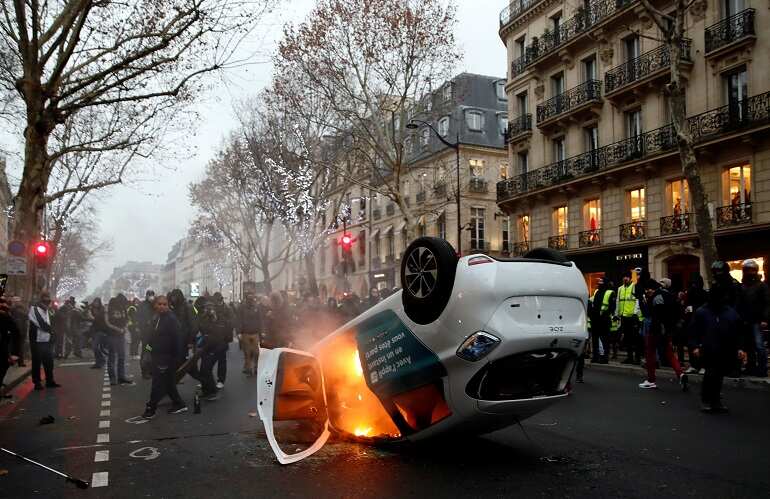 Clashes erupt in Paris as 'yellow vests' protest at unrepentant Macron