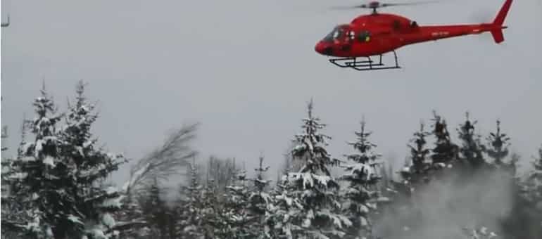 Private helicopter removing layers of snow in Bavaria