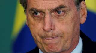 Brazil's Bolsonaro improving after pneumonia, surgery