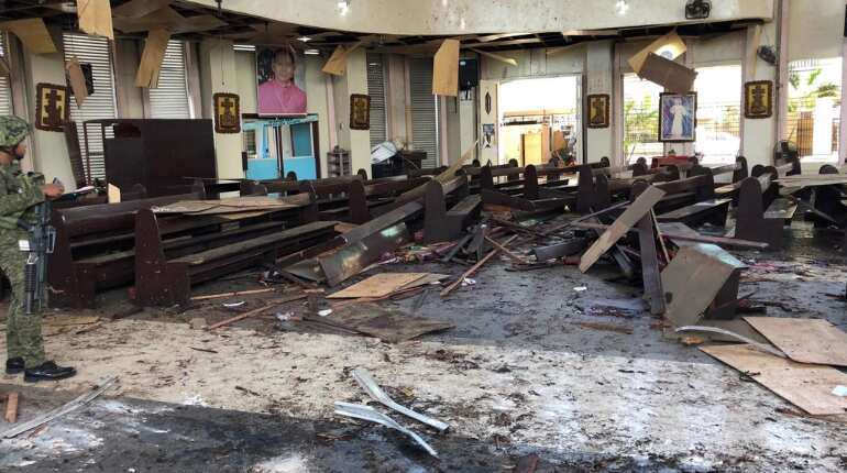 Philippines vows to crush 'terrorists' after church bombs kill 20