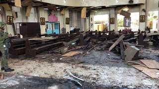 Philippines vows to crush 'terrorists' after church bombs kill 20