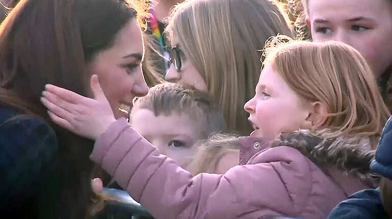 Young girl plays with Duchess of Cambridge's hair