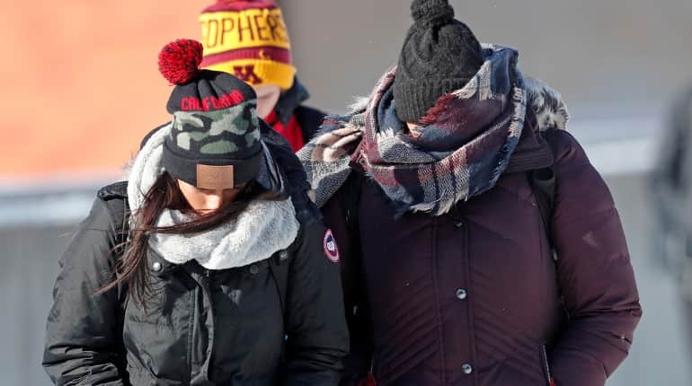 Three sweaters, an undershirt, and a parka