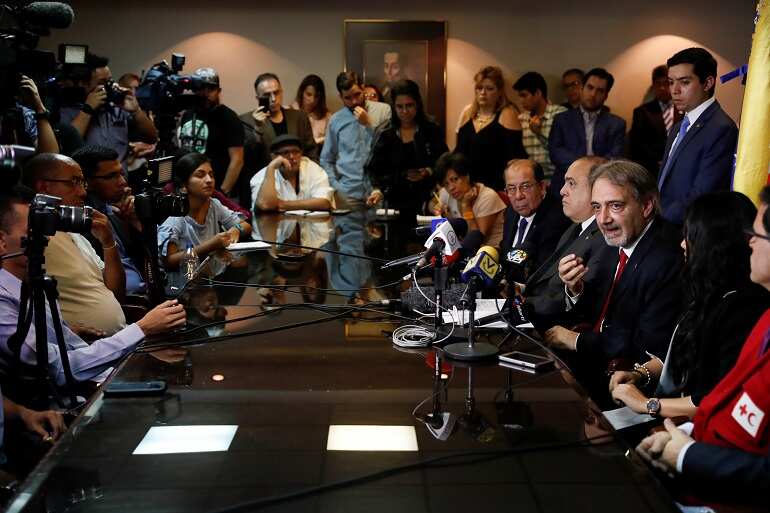Venezuela's Maduro spurns US aid, rival warns military not to block it