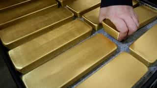 Gold hits two-week low as upbeat US data lifts dollar