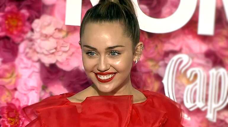 Miley Cyrus takes sick husband's place at movie premiere, joking 'he owes me'