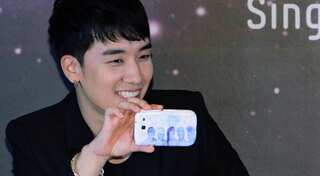 K-pop Big Bang member booked on alleged sex bribery; company shares drop