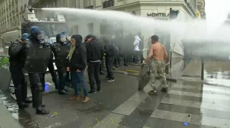 French police use water cannon on Paris protesters French police use water cannon on Paris protesters