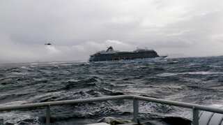 Stricken Norway cruise ship reaches port after third of its passengers are airlifted