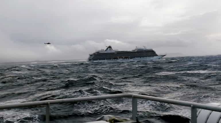 Stricken Norway cruise ship reaches port after third of its passengers are airlifted
