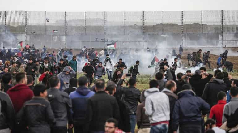 On anniversary, thousands gather at Gaza-Israel border in test of truce