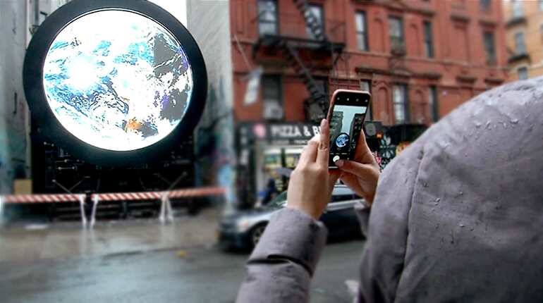 Earth, seen from space, is projected on a giant screen in NY