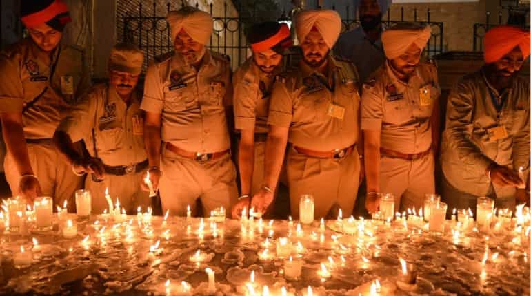 Punjab Police personnel light candles