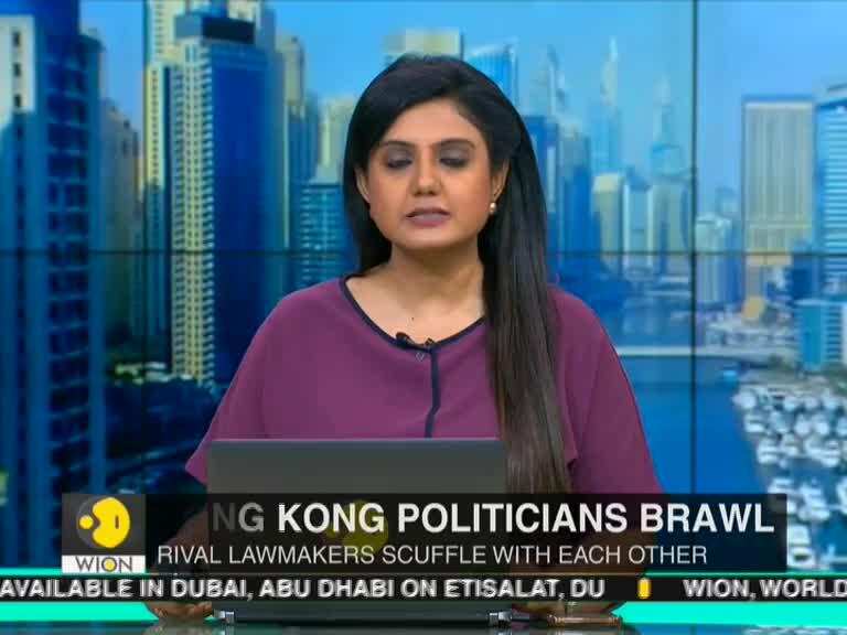 Brawl breaks out in Hong Kong's legislative council, lawmaker wheeled away on stretcher
